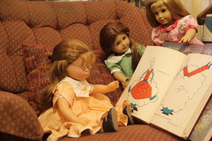The dolls reading a book- see the rest of the story about how they bake a cake on the "Stitching with Ellie" blog