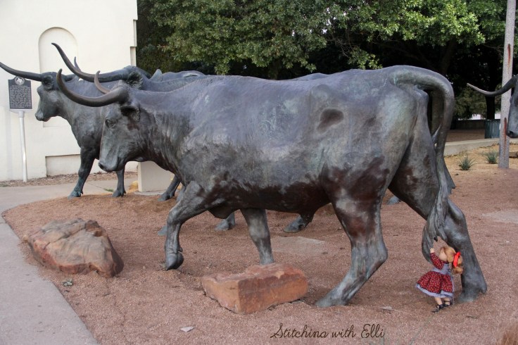 Playing with the cow statues in Waco Texas- a 18" doll photo story by Stitching with Elli