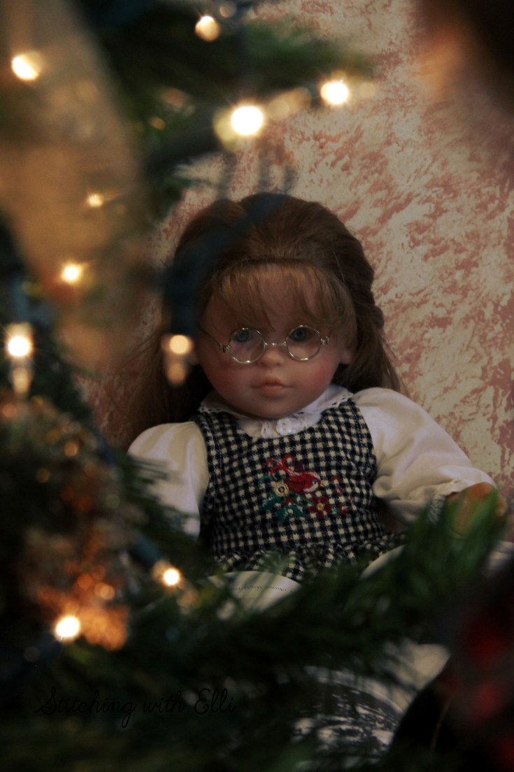 Ellen is reading a Christmas story by the tree- A Christmas photostory by Stitching with Elli