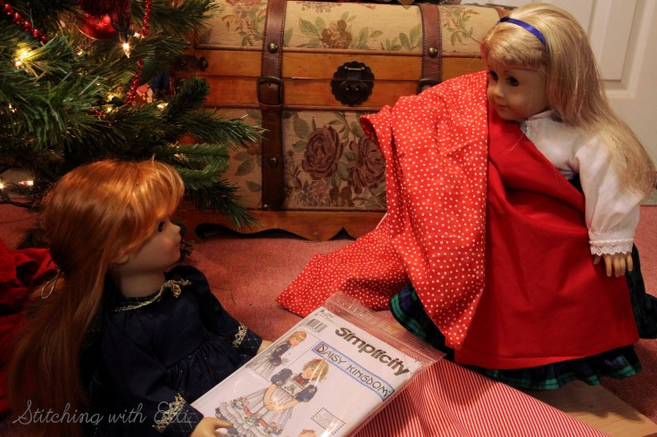 The dolls are sewing a dress for a Christmas present-  by Stitching with Elli