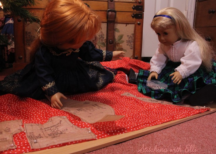The dolls are sewing a dress for a Christmas present-  by Stitching with Elli