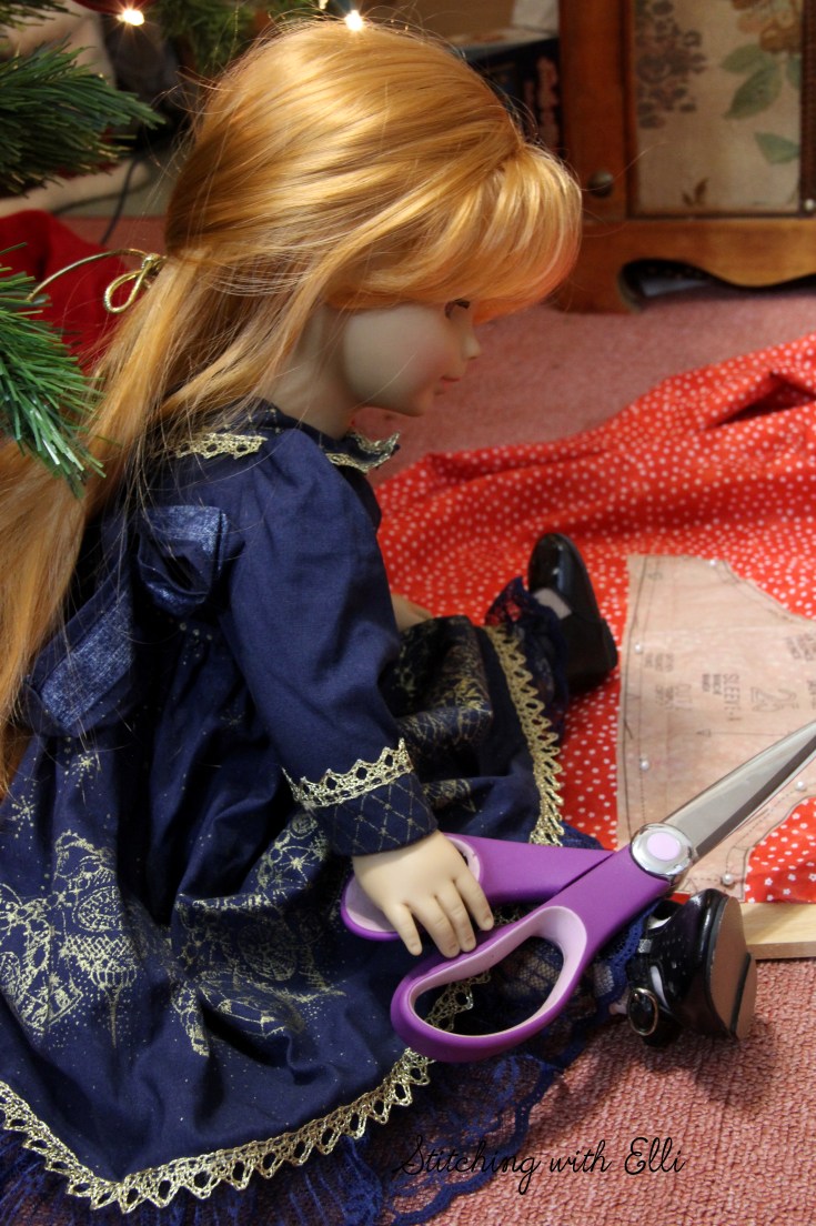 The dolls are sewing a dress for a Christmas present-  by Stitching with Elli
