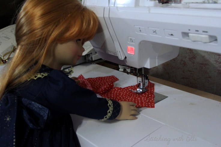 The dolls are sewing a dress for a Christmas present-  by Stitching with Elli