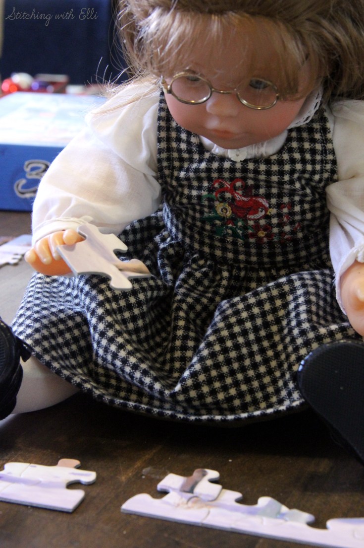 Spending time together working on a puzzle is a fun thing to do around Christmas time- by Stitching with Elli