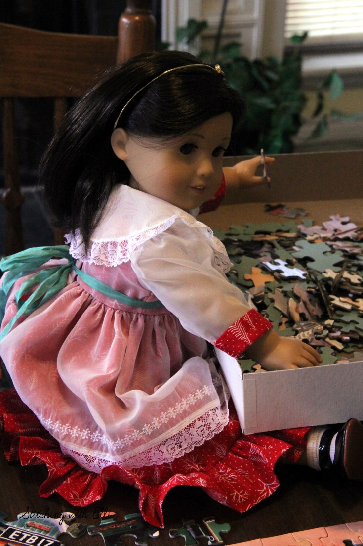 Spending time together working on a puzzle is a fun thing to do around Christmas time- by Stitching with Elli