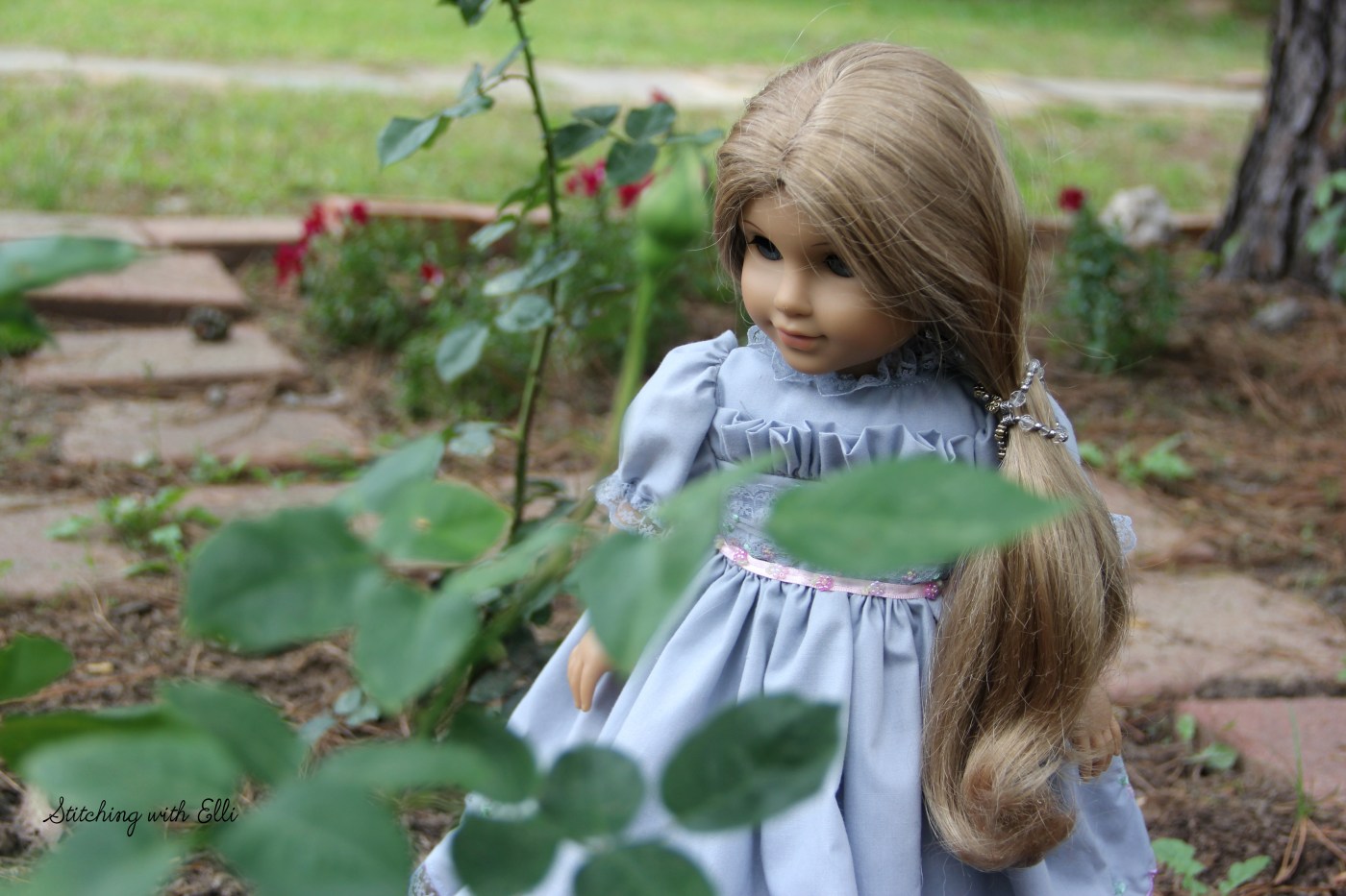 Elizabeth is working in the rose garden- see the story on stitchingwithelli.com