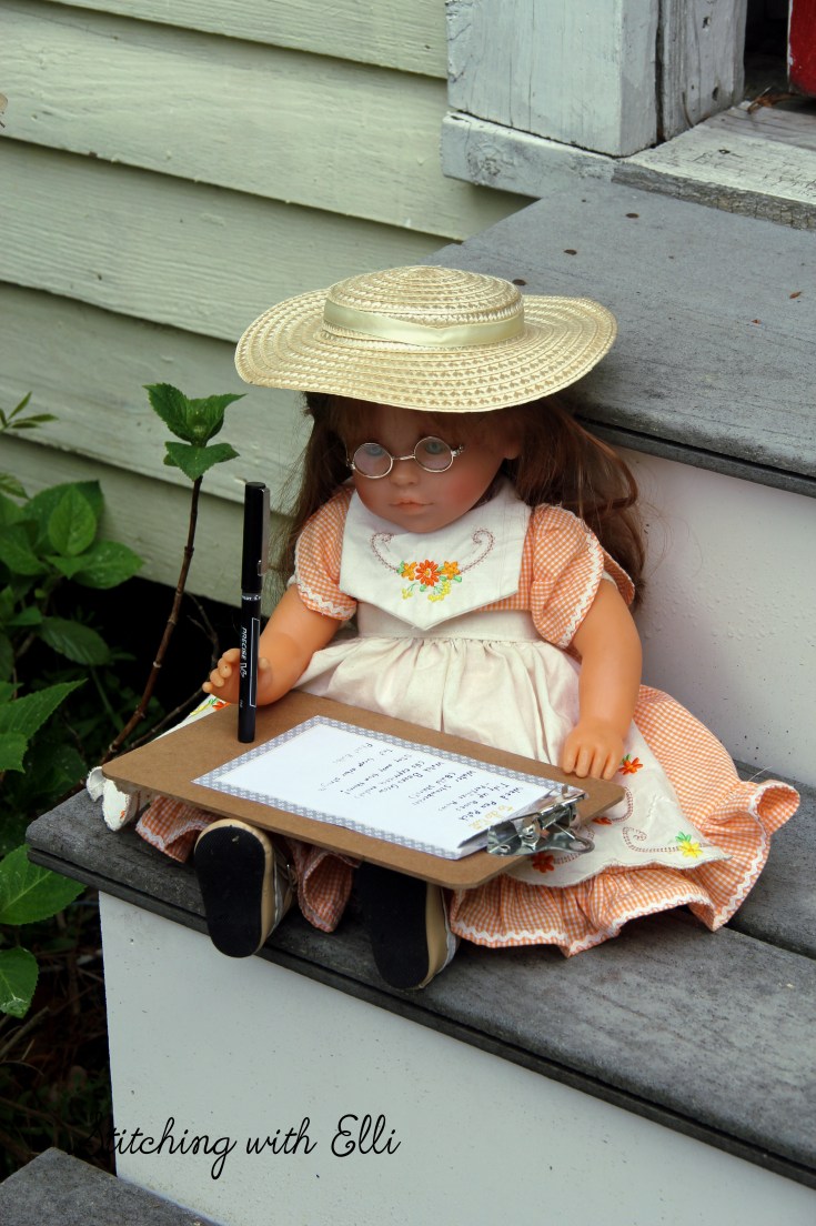 Ellen checks over her list for the garden- see the whole story on www.stitchingwithelli.com